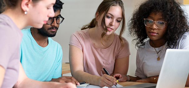 Group of students studying on a laptop with help from study abroad agencies in Kerala